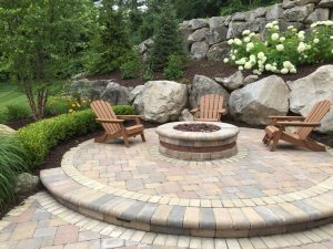stone outdoor living space with fire pit