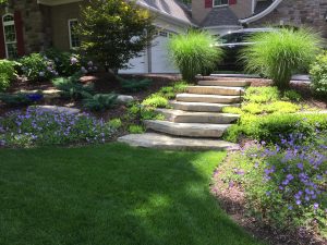 Landscaping with stone stairs and flower beds