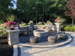 stone outdoor seating area with stone firepit