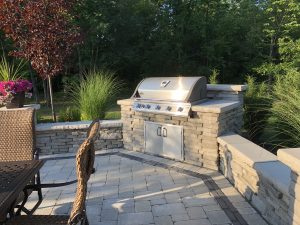Stone outdoor cooking and seating area